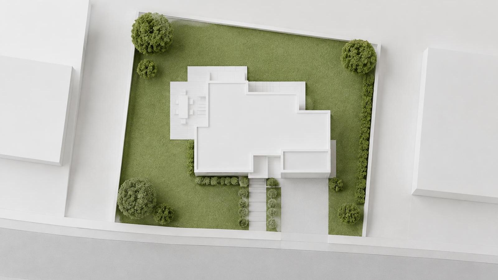 Maquete vista de cima com a projeção de uma casa sobre o lote e área de jardim, ilustrando a taxa de ocupação