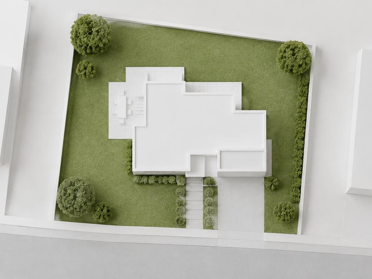 Maquete vista de cima com a projeção de uma casa sobre o lote e área de jardim, ilustrando a taxa de ocupação